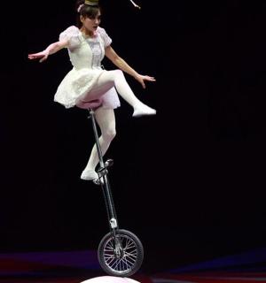 a woman in a dress is riding a scooter