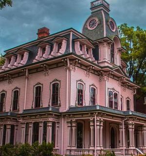ein rosa Gebäude mit einem Uhrenturm darauf