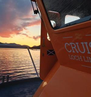 a boat on a body of water with a sunset