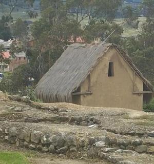 a small building with a roof on a hill