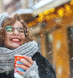 žena držící šálek kávy ve sněhu