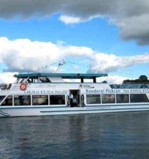 a white boat in the water on a river