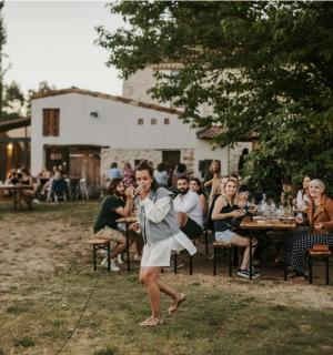 a woman is dancing in front of a group of people