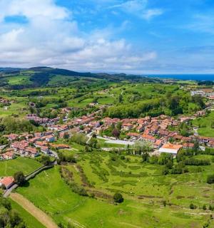 an aerial view of a small village in the hills