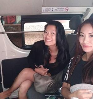 two women sitting in the back of a car