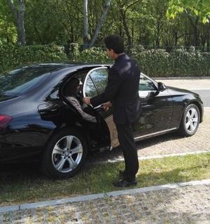 a man standing next to a black car