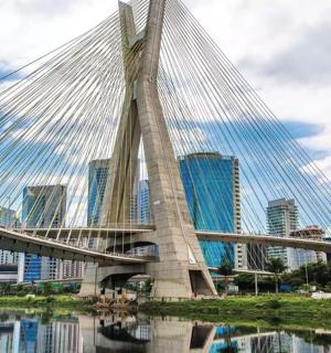a bridge over a body of water with buildings
