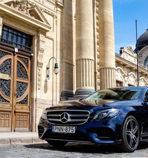 a blue car parked in front of a building
