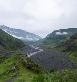 a view of a river in a valley with mountains