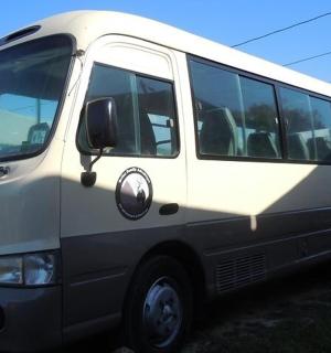 a white bus parked in a parking lot