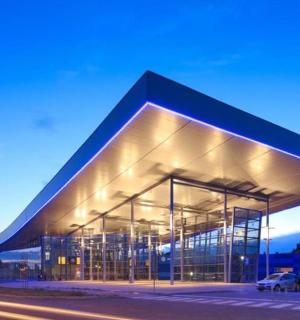 a large building with a blue roof on a street