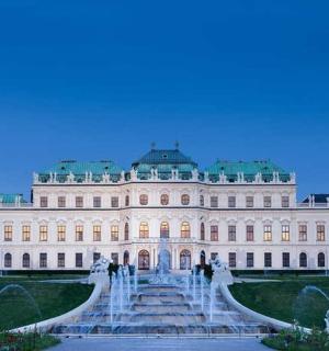 a large white building with a fountain in front of it