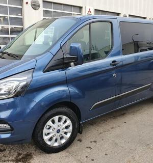 a blue van parked in a parking lot