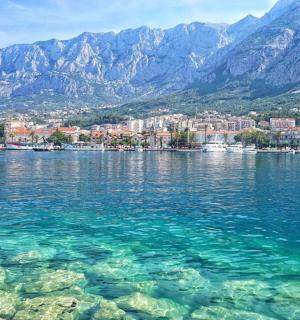 a large body of water with mountains in the background