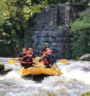 a group of people in a raft in a river