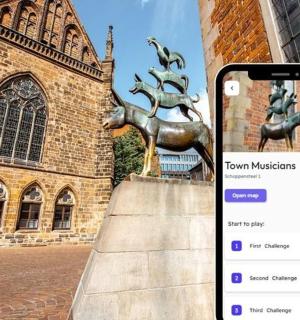 a cell phone in front of a statue in front of a building