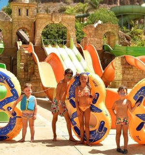 a group of children standing in front of a water park