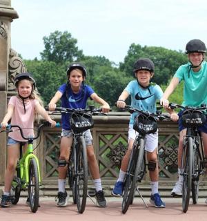 a group of children on bikes on a bridge
