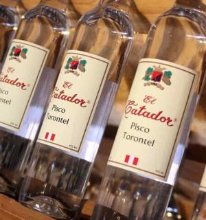 a bunch of wine bottles sitting on a shelf