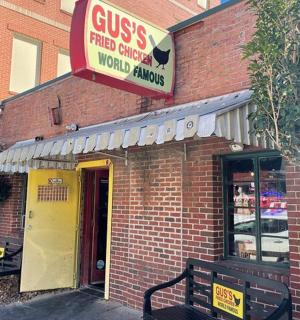 a fast food restaurant with a sign on a building