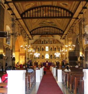 a large church with people sitting in the altar
