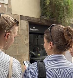 two women standing in front of a store