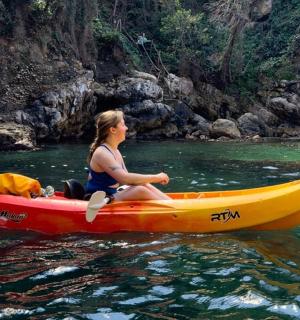 a woman sitting on a kayak in the water
