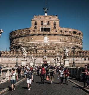 a group of people walking in front of a building