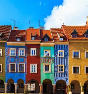 a row of colorful buildings with red roofs