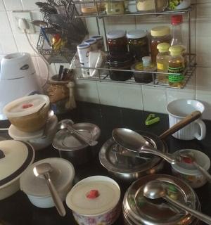 a kitchen counter with pots and pans and utensils