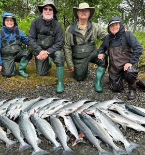 a group of people standing next to a group of fish