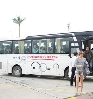 a group of people standing in front of a bus