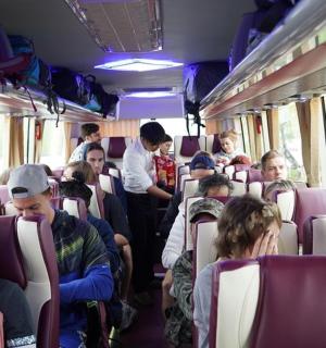 a group of people sitting on a bus