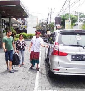 a group of people standing next to a car