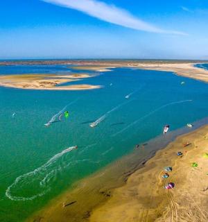 an aerial view of a beach with people in the water