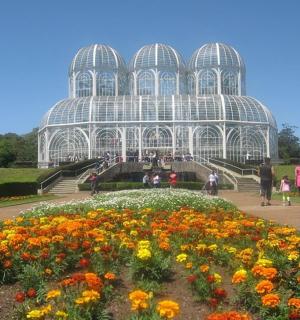 a greenhouse with a bunch of flowers in front of it
