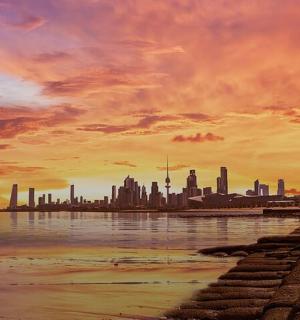 a painting of a city skyline with the water