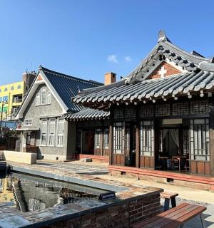 an asian style building with a pond in front of it
