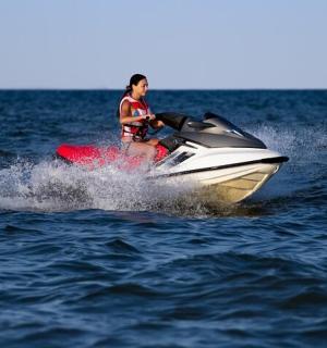 a woman riding on a jet ski in the water