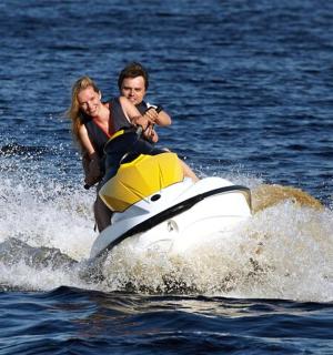 一男一女在水中驾驶水上摩托艇
