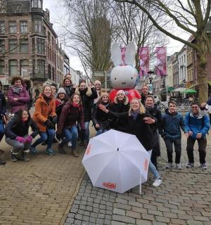 a group of people posing for a picture on a street