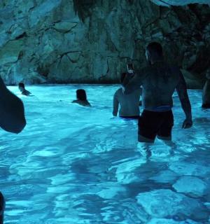 a group of people in a swimming pool in a cave