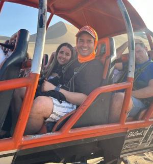a group of people sitting in a ride in the desert