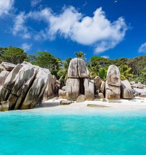 a group of large rocks on a beach