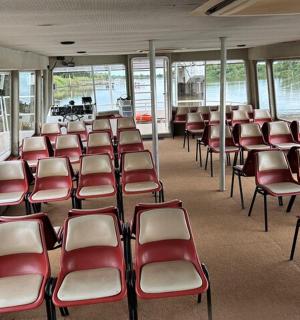 an empty room with red and white chairs