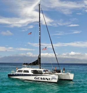 a white sailboat in the water on the ocean