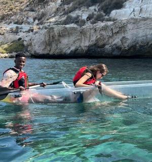 a man and a woman in a canoe in the water