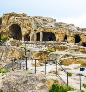 a rock mountain with a cave in it