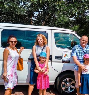 a group of people standing in front of a van