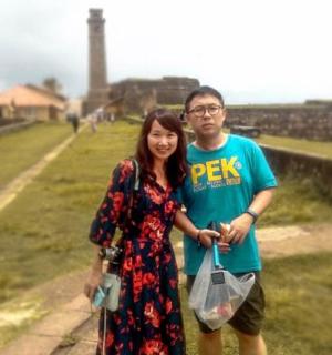 a man and a woman standing on a wall